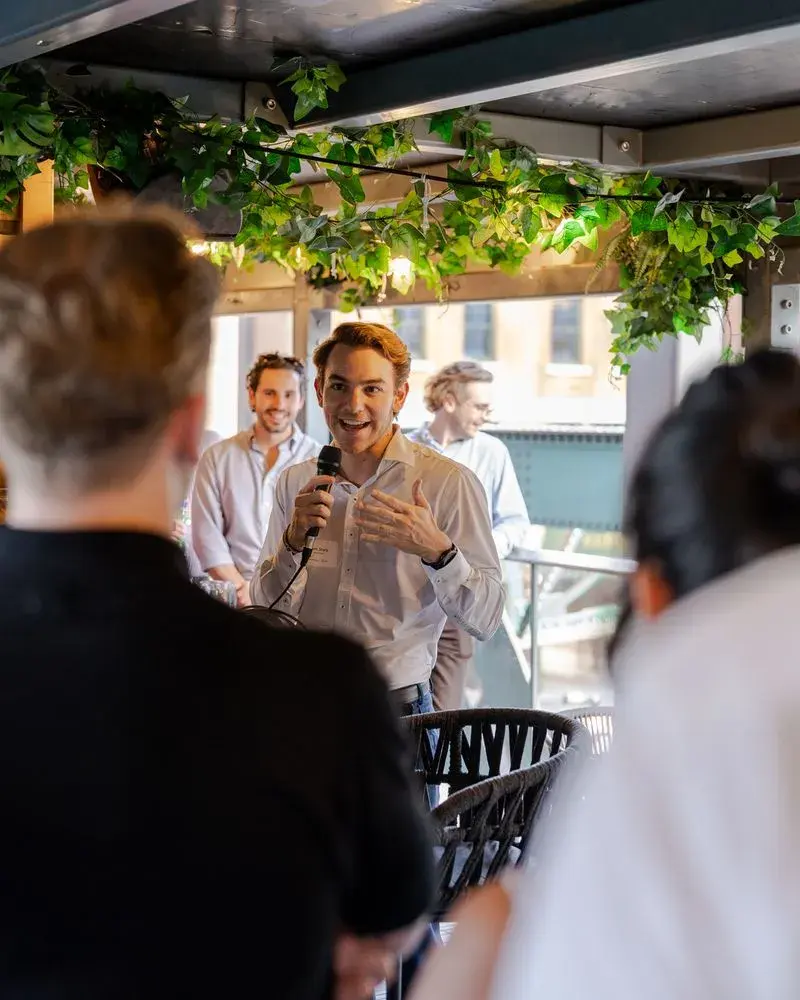 Sam Stark of Green Project addressing attendees at a networking event during London Climate Action Week